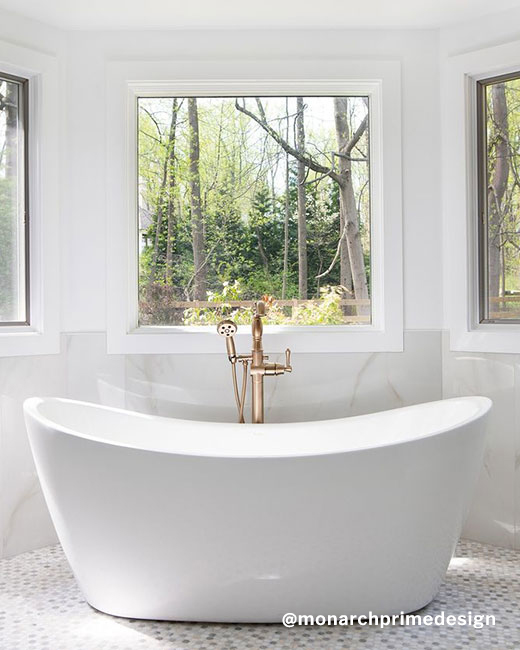 a white acrylic freestanding bathtub standing out as a centerpiece in a luxury bathroom