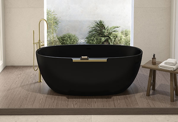 a sleek matte black ova bathtub with brushed gold hardware in a nature-inspired bathroom design.