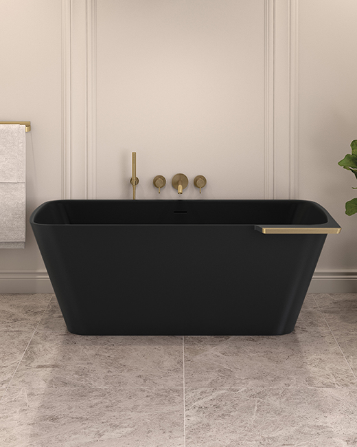 a rectangular solid surface freestanding bathtub in matte black with brushed gold trim