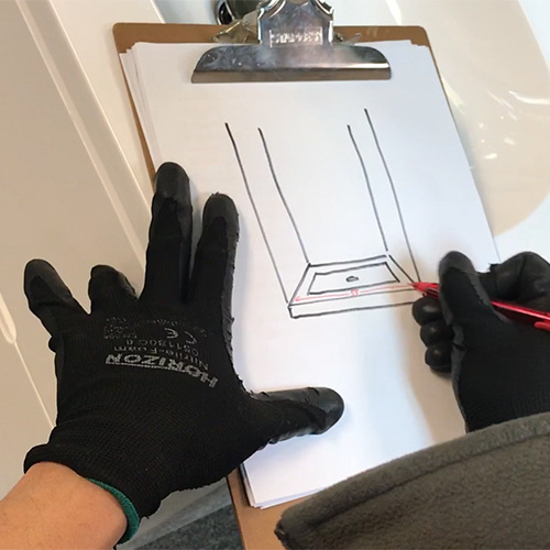 fleurco installer marking down the bottom measurement on their drawing